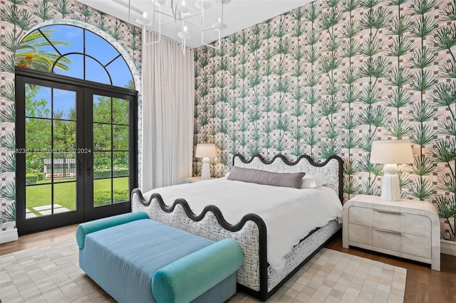 bedroom featuring french doors, light hardwood / wood-style flooring, and access to exterior