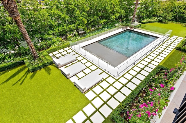 view of swimming pool with a lawn