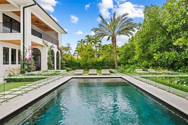 406 Tamarind Dr, Hallandale Beach, FL 33009 - swimming pool featuring a ceiling fan and a patio area