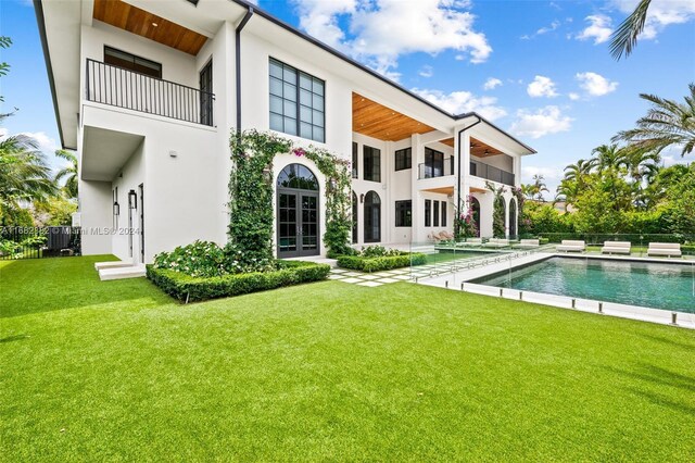 406 Tamarind Dr, Hallandale Beach, FL 33009 - rear view of property with a balcony, stucco siding, cooling unit, and a patio