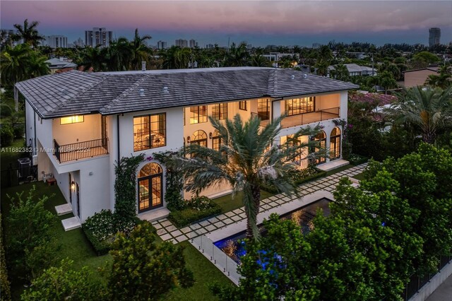 406 Tamarind Dr, Hallandale Beach, FL 33009 - view of front facade with a balcony, stucco siding, and french doors