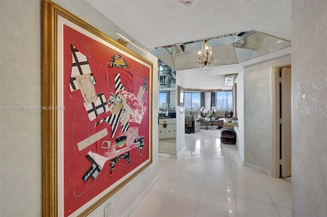 corridor featuring a notable chandelier and light tile patterned floors