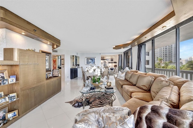 living room featuring a textured ceiling and light tile patterned flooring