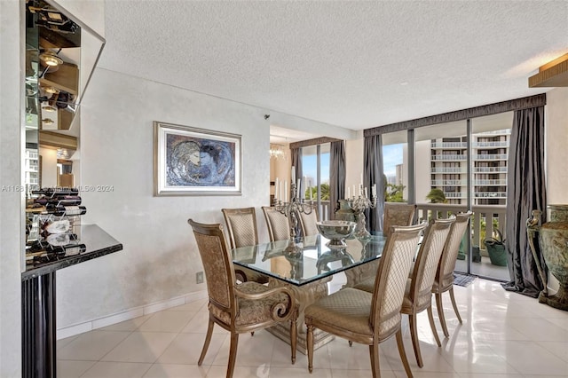 dining space with a textured ceiling, floor to ceiling windows, and light tile patterned floors