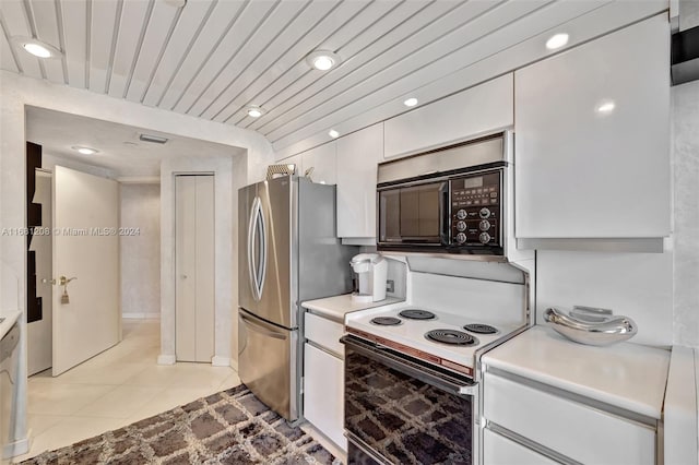 kitchen with stainless steel fridge, white cabinets, wooden ceiling, white range with electric cooktop, and light tile patterned flooring