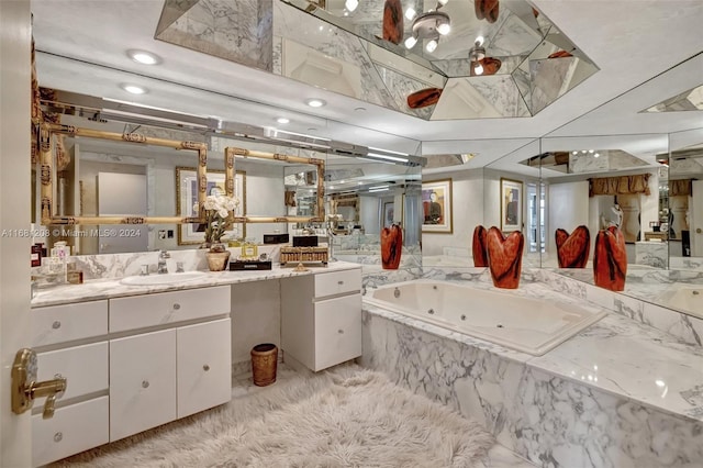 bathroom with vanity and a relaxing tiled tub