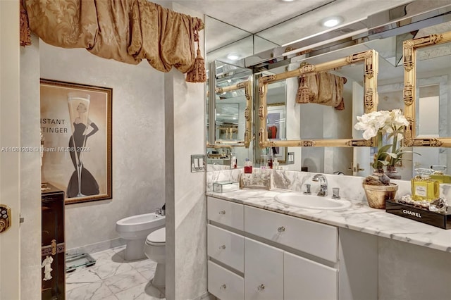 bathroom with vanity, a bidet, and toilet