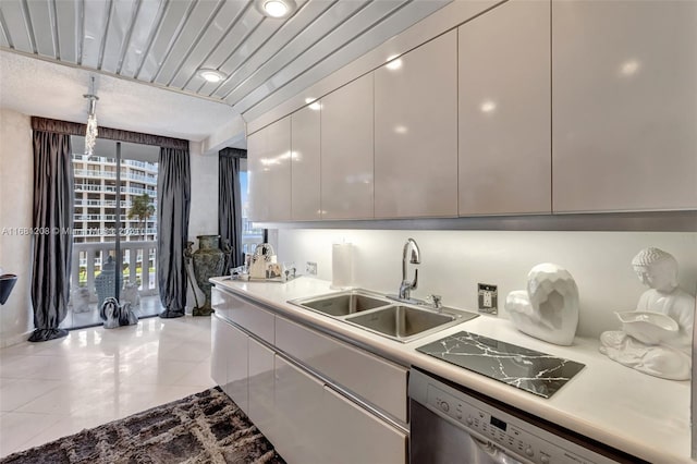 kitchen with light tile patterned floors, sink, and dishwasher