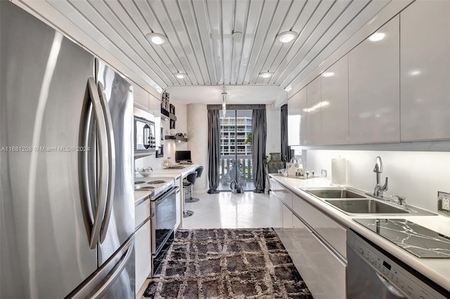 kitchen featuring sink, wood ceiling, hanging light fixtures, white cabinetry, and stainless steel appliances