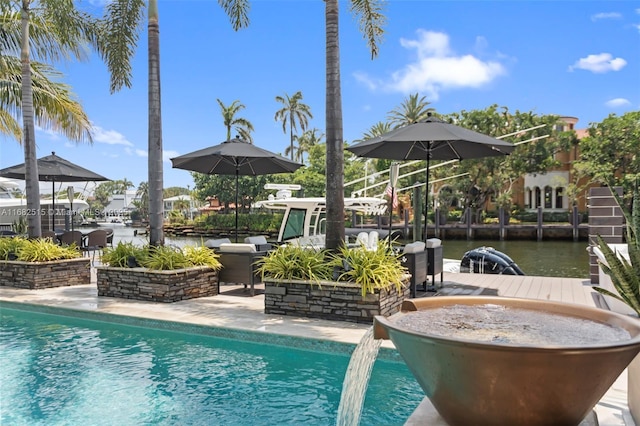 view of pool with a water view and a patio area