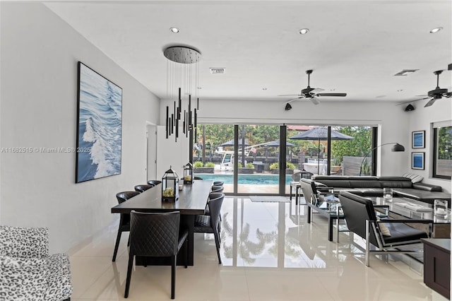 dining space with light tile patterned floors and ceiling fan