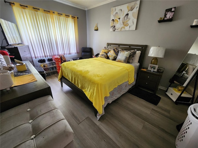 bedroom with crown molding and dark hardwood / wood-style flooring