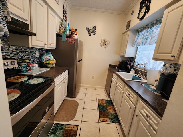 kitchen featuring sink, appliances with stainless steel finishes, white cabinets, and light tile patterned floors