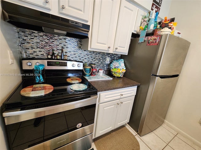 kitchen featuring white cabinets, stainless steel appliances, backsplash, and light tile patterned flooring