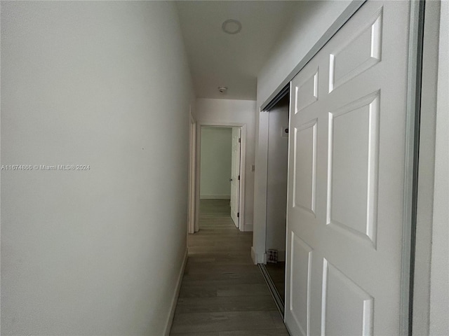 corridor featuring dark hardwood / wood-style flooring