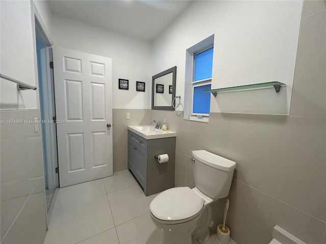 bathroom featuring vanity, toilet, and tile patterned flooring