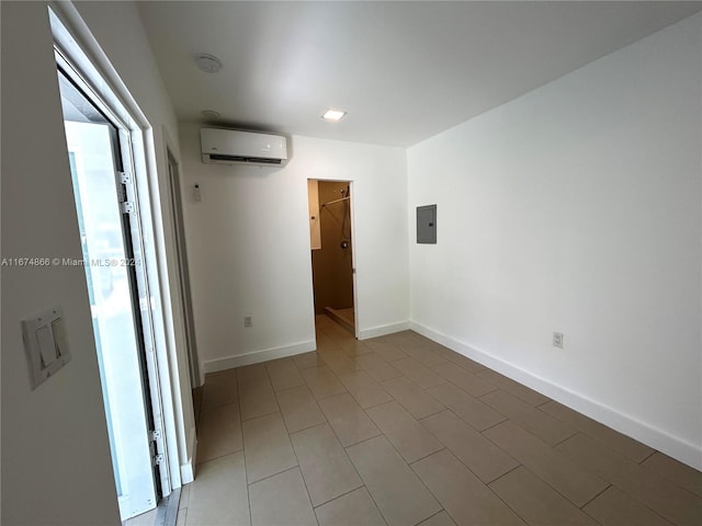 spare room featuring electric panel and a wall unit AC