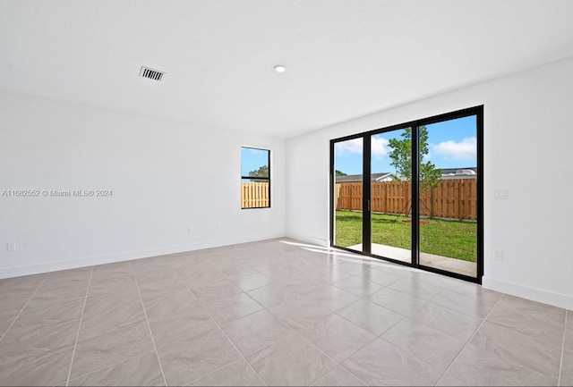 unfurnished room with light tile patterned floors