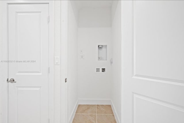 clothes washing area featuring electric dryer hookup, washer hookup, and light tile patterned flooring