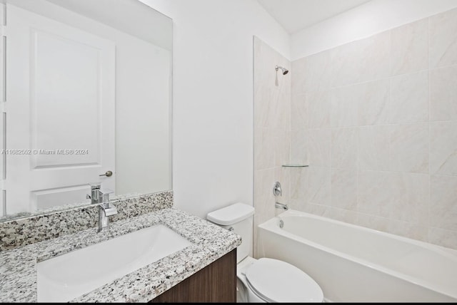 full bathroom with tiled shower / bath, vanity, and toilet