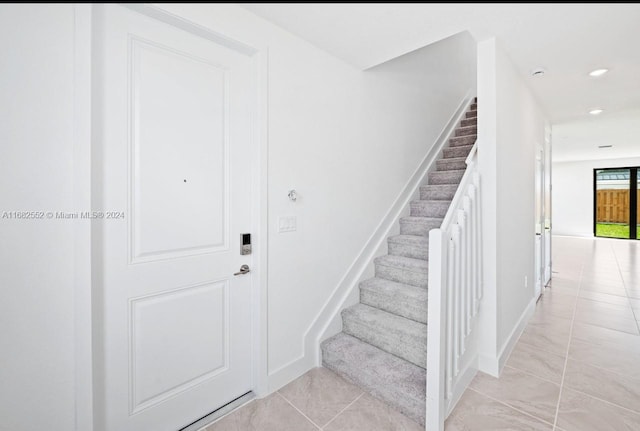 stairs featuring tile patterned flooring