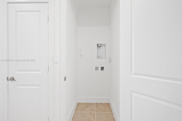 clothes washing area featuring hookup for an electric dryer, light tile patterned flooring, and washer hookup