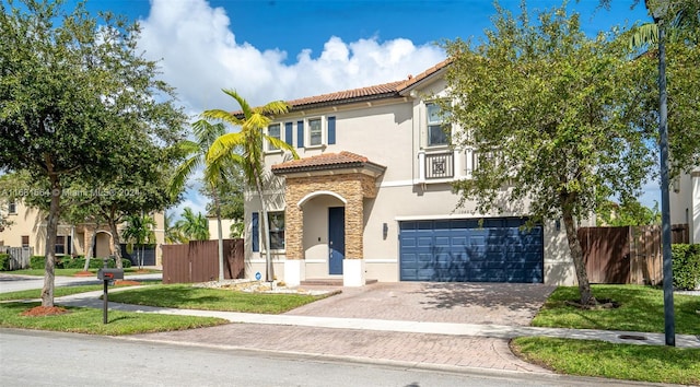 mediterranean / spanish home with a garage