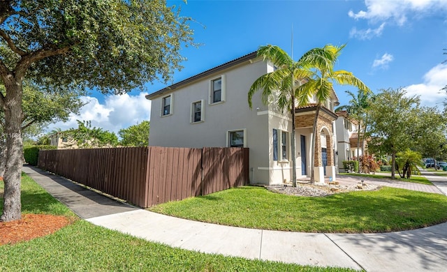 view of property exterior with a yard