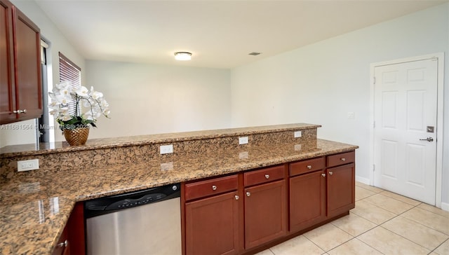 kitchen with stone counters, dishwasher, and light tile patterned floors