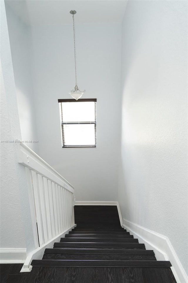 stairs featuring wood-type flooring