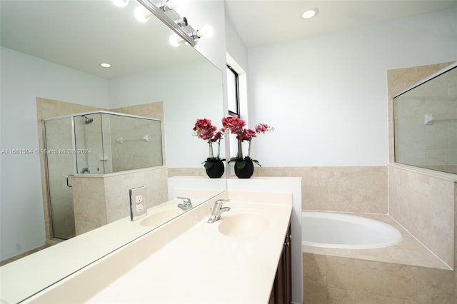 bathroom featuring vanity and plus walk in shower