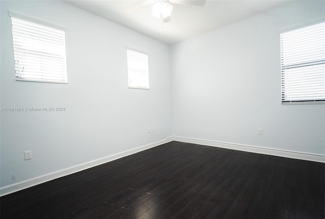 empty room featuring ceiling fan and dark hardwood / wood-style flooring