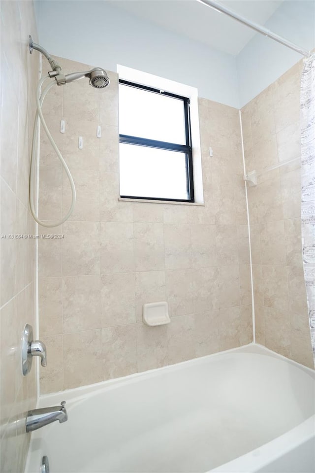 bathroom featuring shower / tub combo with curtain