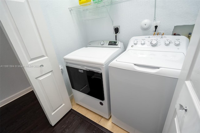 washroom featuring wood-type flooring and washer and clothes dryer