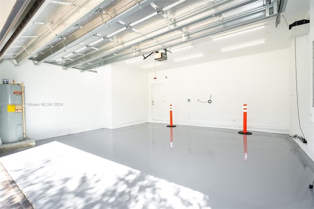 garage featuring a garage door opener and water heater