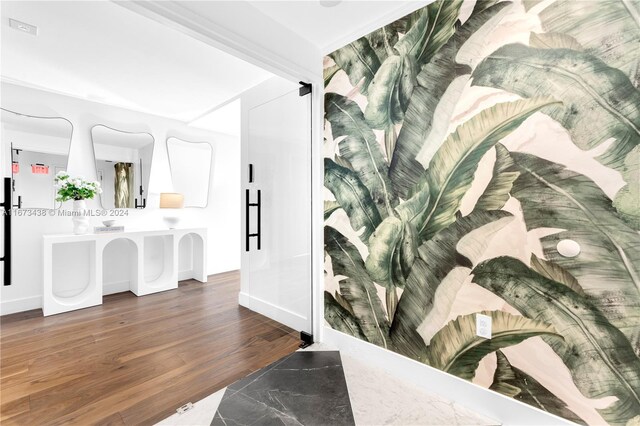 interior space featuring baseboards and wood finished floors