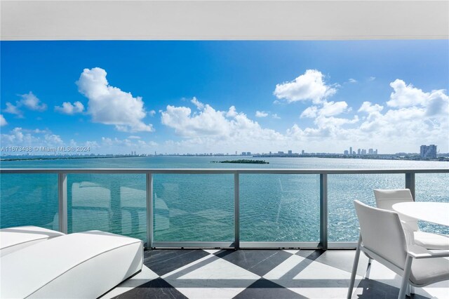 balcony featuring a water view and a view of city