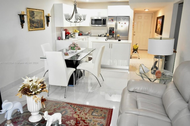 dining room featuring a notable chandelier and sink