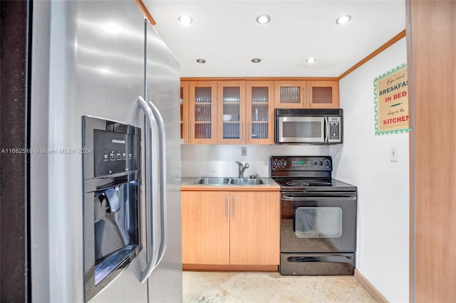 kitchen featuring stainless steel appliances, ornamental molding, and sink