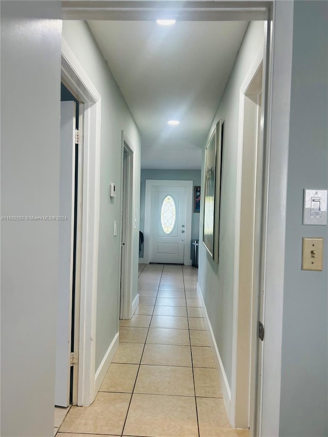 hall with light tile patterned floors