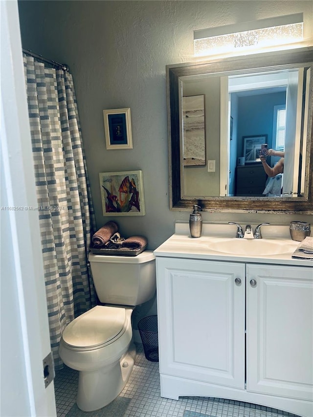 bathroom featuring vanity, toilet, and tile patterned floors