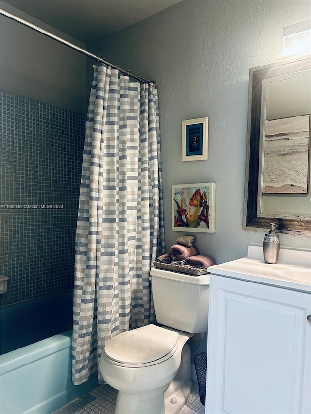 full bathroom featuring vanity, toilet, tile patterned floors, and shower / bath combo with shower curtain