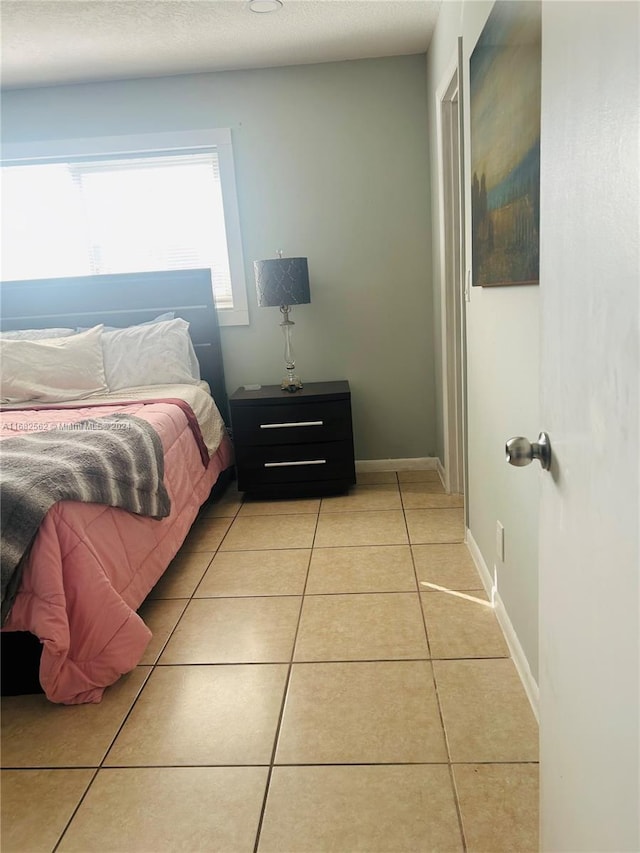 bedroom featuring light tile patterned flooring