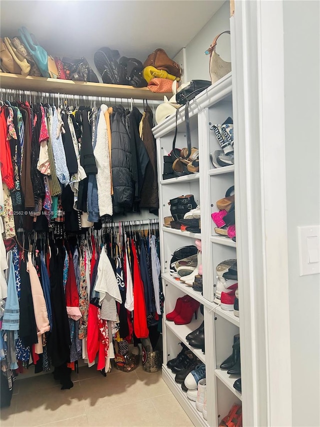 spacious closet featuring tile patterned floors