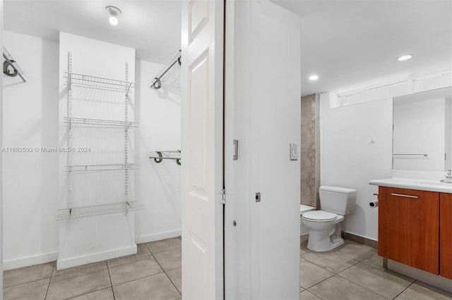 bathroom with vanity, toilet, and tile patterned flooring