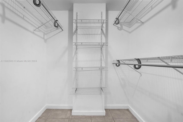 spacious closet featuring light tile patterned flooring