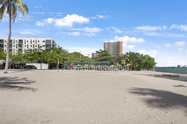 view of home's community featuring volleyball court and a water view