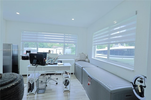 home office with plenty of natural light and light wood-type flooring