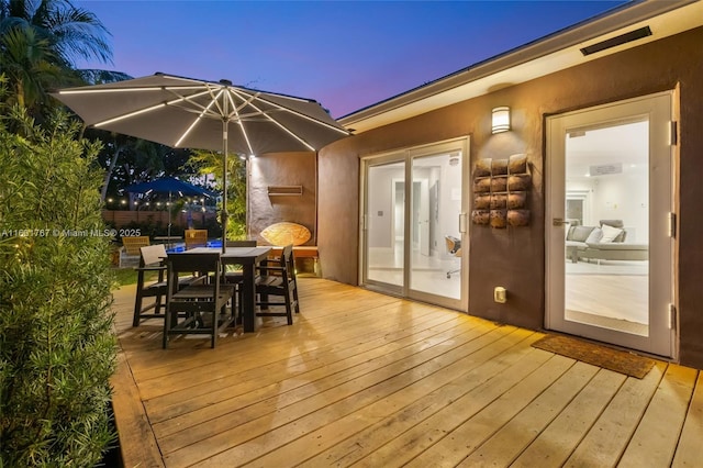 wooden terrace with outdoor dining space