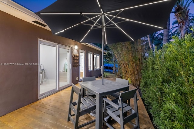 wooden deck with outdoor dining area